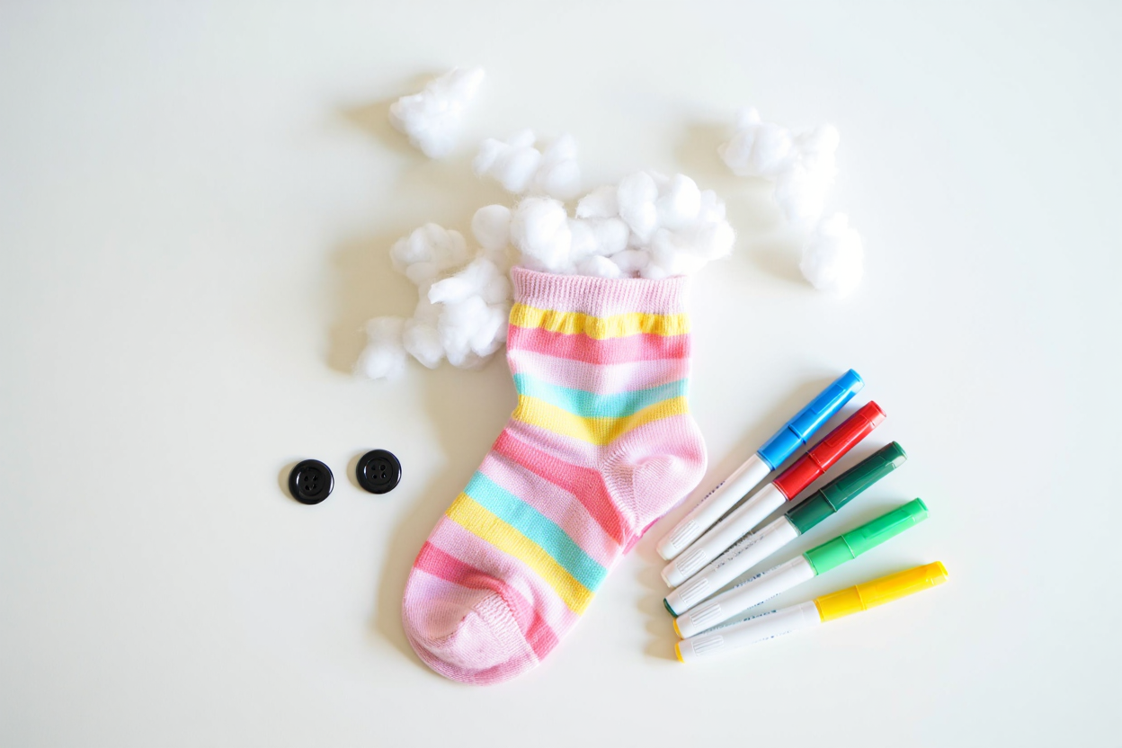 Materials for breathing buddy: colorful sock, cotton balls, buttons, and markers